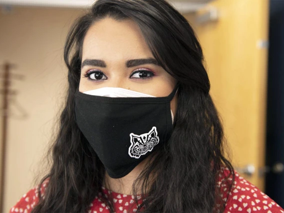 Maryell Martinez, administrative associate for the Mel and Enid Zuckerman College of Public Health’s Phoenix campus, wears a black mask with a wildcat incorporating the man in the maze motif, a sacred symbol of the Tohono O’odham people. 