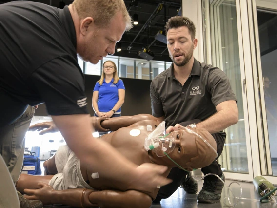 Using lifelike manikins, ASTEC personnel train staff from a local drug rehab facility to treat overdose with naloxone.