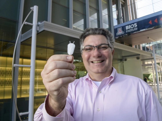 Klearchos Papas, PhD, director of the College of Medicine – Tucson’s Institute for Cellular Transplantation, holds a synthetic nanoporous pouch used in an implantable cell therapy device to provide insulin for Type 1 diabetes patients.