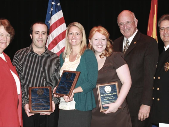 Professor Kelly Reynolds, PhD, MSPH, and two graduate students are presented with the Tucson Fire Department’s Award of Service at a ceremony in the Tucson Convention Center on Feb. 19, 2010. Pictured from left: Tucson City Councilwoman Shirley Scott; Jonathan Sexton, PhD; Dr. Reynolds; student Kelly Hager; Tucson Mayor Bob Walkup; Tucson Fire Chief Patrick Kelly.