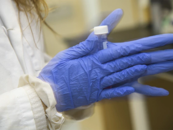 A lab worker shakes up a compound in one of the new College of Pharmacy laboratories being used for drug discovery research.