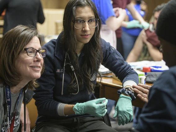 Street Medicine Phoenix preceptor Susan Kaib, MD, and first-year College of Medicine - Phoenix student volunteer Sara Yee get to know a patient.