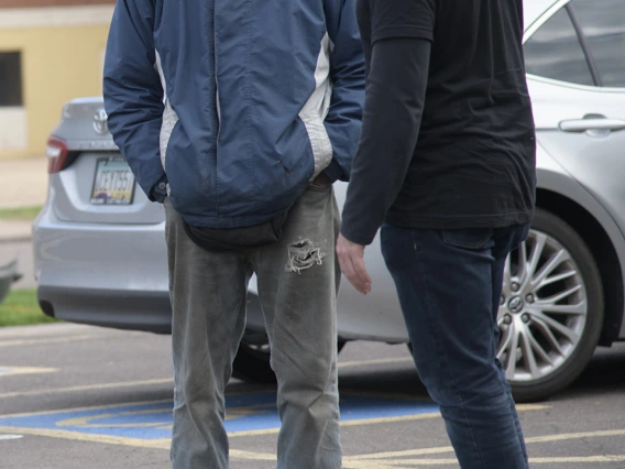 Street Medicine Phoenix co-founder Jeffery Hanna speaks with a patient outside of Grace Lutheran Church.