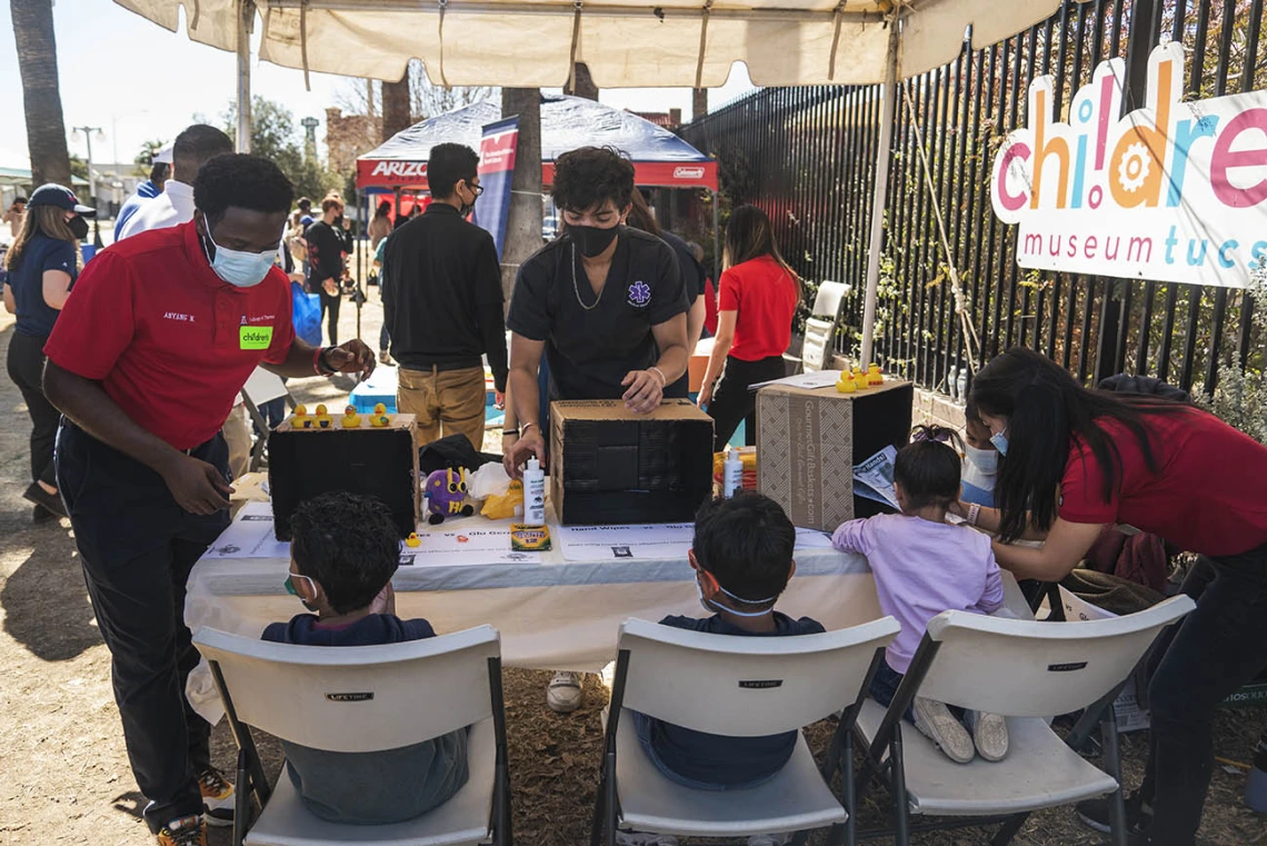 Student volunteers from the University of Arizona R. Ken Coit College of Pharmacy and Medical Directive students show kids where germs like to hide on your hands and demonstrate the importance of washing your hands well during the recent Family SciFest at Children's Museum Tucson.