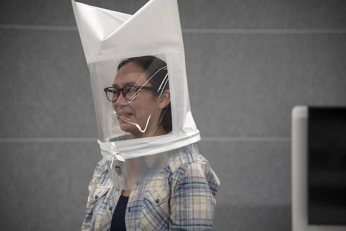 Bitters are sprayed directly into second-year College of Medicine – Tucson student Emerald Montgomery’s hooded mask. Her reaction shows that she is able to taste the bitters. Testers will know her equipment is properly fitted once she is no longer able to taste them.