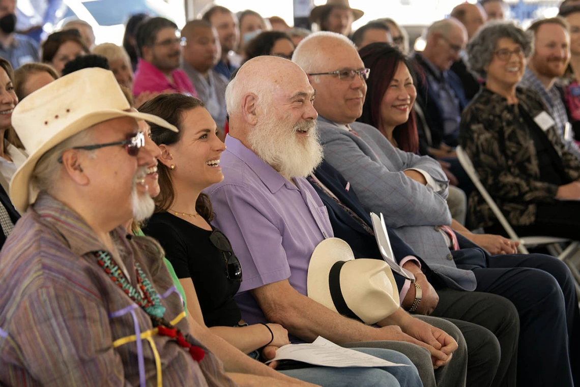 Andrew Weil, MD, (center in purple) laughs along with other attendees of the groundbreaking ceremony for the Andrew Weil Center for Integrative Medicine as University of Arizona President, Robert C. Robbins, MD, relays an anecdote from their first meeting many years ago. 