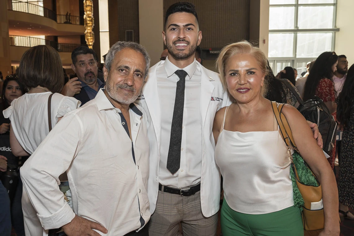 Michael Mazarei (center) poses with his father, Ali Mazarei, and mother, Minoo Ashouri, after the UArizona College of Medicine – Phoenix Class of 2026 white coat ceremony.