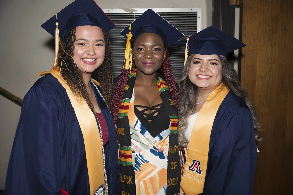 (From left) Deja Taggart, Minette Anu and Yatzel Alvarez pause backstage at Centennial Hall during the College of Nursing’s 2022 summer convocation before receiving their bachelor’s degrees in nursing integrative health pathway.