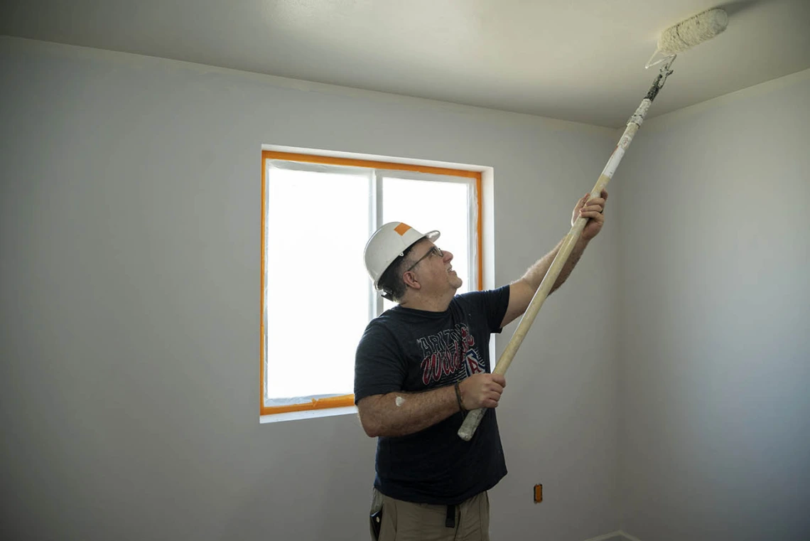 Albert Fiorello, MD, FAAEM, FACEP, an associate professor in the College of Medicine – Tucson’s Department of Emergency Medicine, rolls paint on the ceiling of a Habitat for Humanity house during the EM Day of Service.  