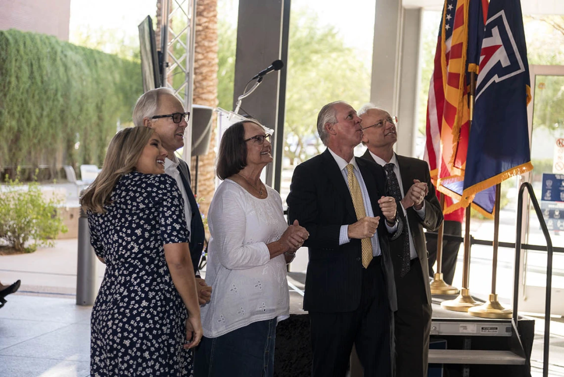 The Coit family along with President Robbins and Pharmacy Dean Schnellmann take in the new R. Ken Coit College of Pharmacy signage on the side of the building after the unveiling ceremony. 