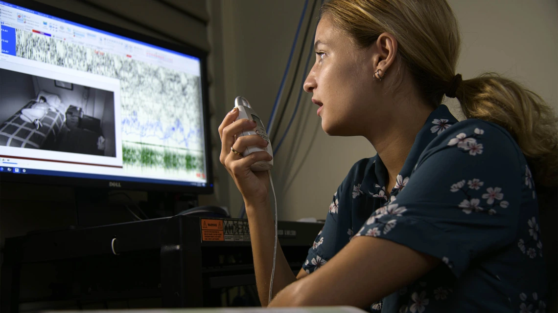 Caleigh Shepard, a former specialized research assistant, speaks to a sleep research study participant in the UArizona Social, Cognitive, and Affective Neuroscience Lab (SCAN Lab).