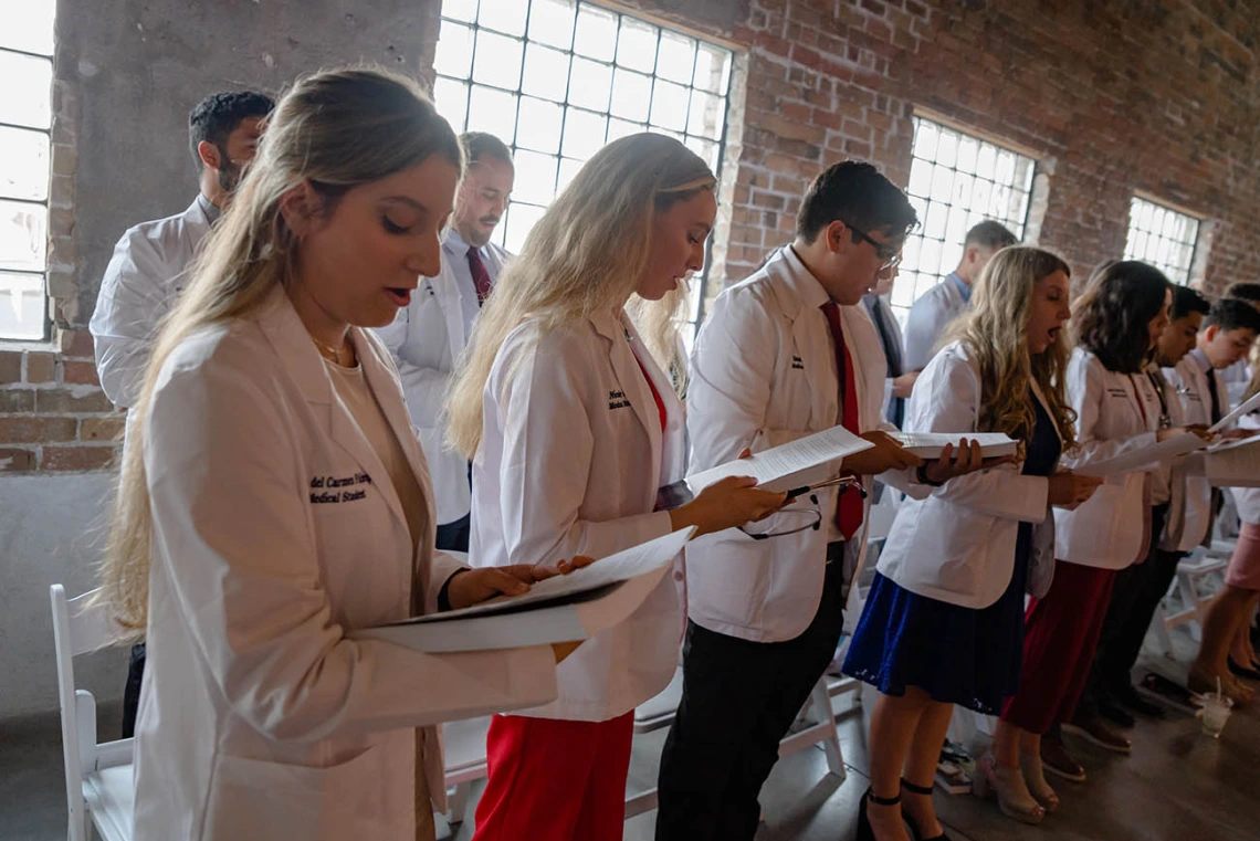 Sofia Fabrega, Nicole Falls, Saul Favila, Blake Feldmar and fellow med students read their oath during the ceremony.