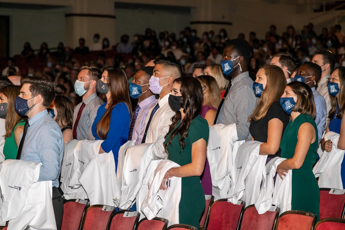 Medical students recite the mission statement during the Class of 2025 white coat ceremony at Centennial Hall.