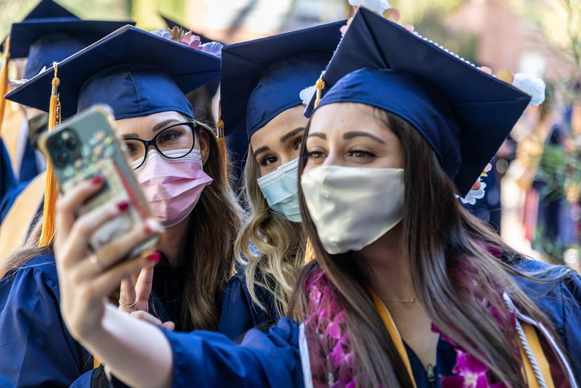 (From left) Nicole Cook, Maia Cochran and Shannon Cloughley pose for a selfie before the start of the College of Nursing fall convocation at Centennial Hall.