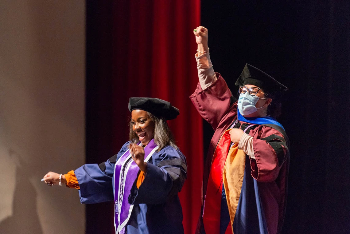 Yarmoni Yharbough (left) and her committee chair Evangeline Dowling, PhD, MSN/Ed, celebrate after Yharbough is hooded for earning her Doctor of Nursing Practice during the College of Nursing fall convocation.