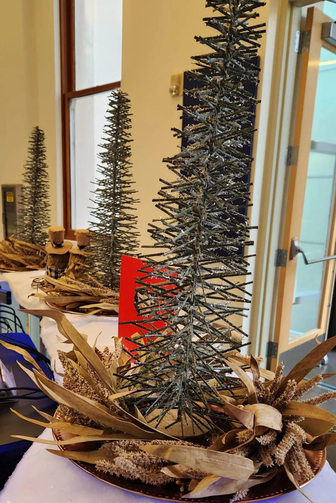 Wooden Christmas trees and fluffy cotton “snow” adorn the reception desk and lobby of Building 1 at the Phoenix Bioscience Core.