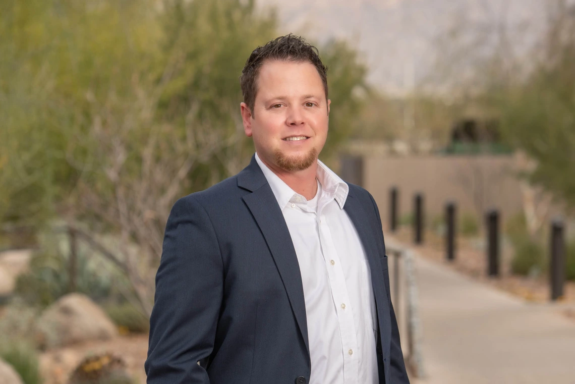 Portrait of Noel Warfel standing outside the University of Arizona Cancer Center