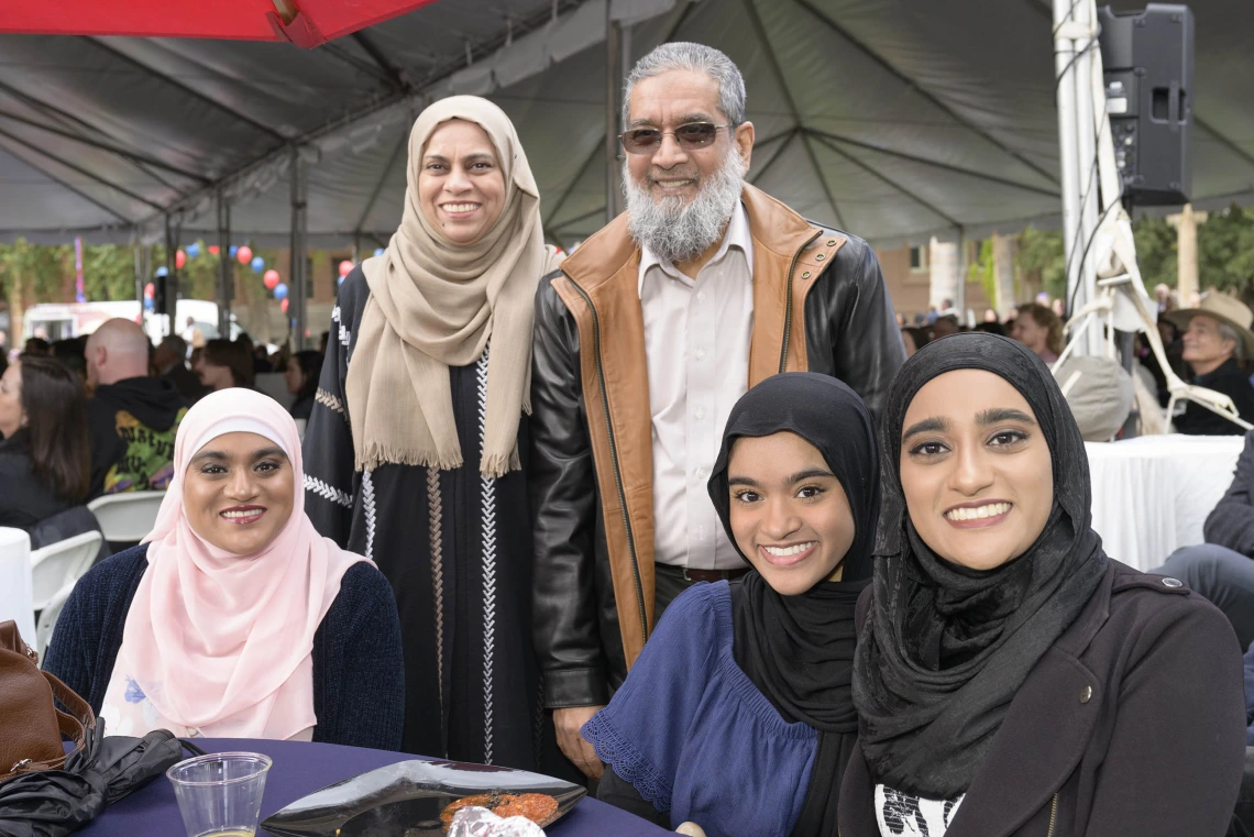 A family sits around a table, all smiling, at the University of Arizona College of Medicine – Tucson Match Day celebration.