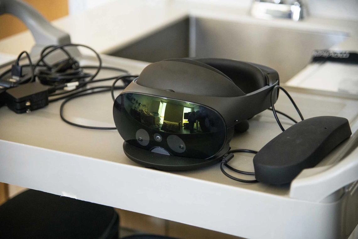 A virtual reality headset sits on a table.