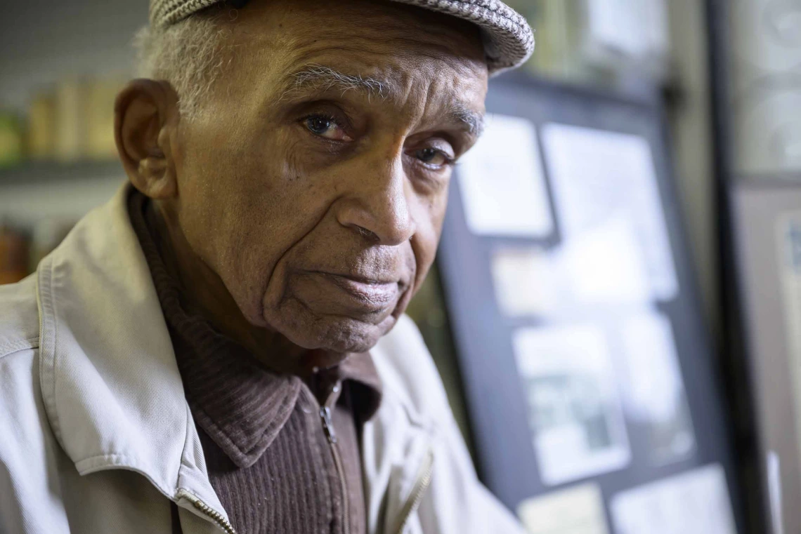 Portrait of 92-year-old Charles Kendrick wearing a flat cap. 