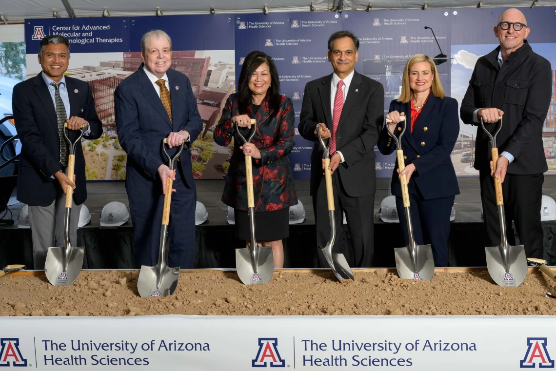 group of people pose with shovels at the groundbreaking ceremony for the Center for Advanced Molecular and Immunological Therapies