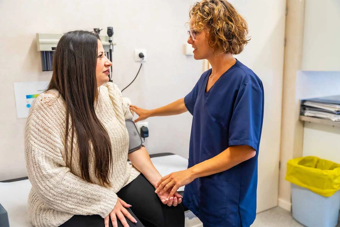 Physician assistant measuring a patient's blood pressure 