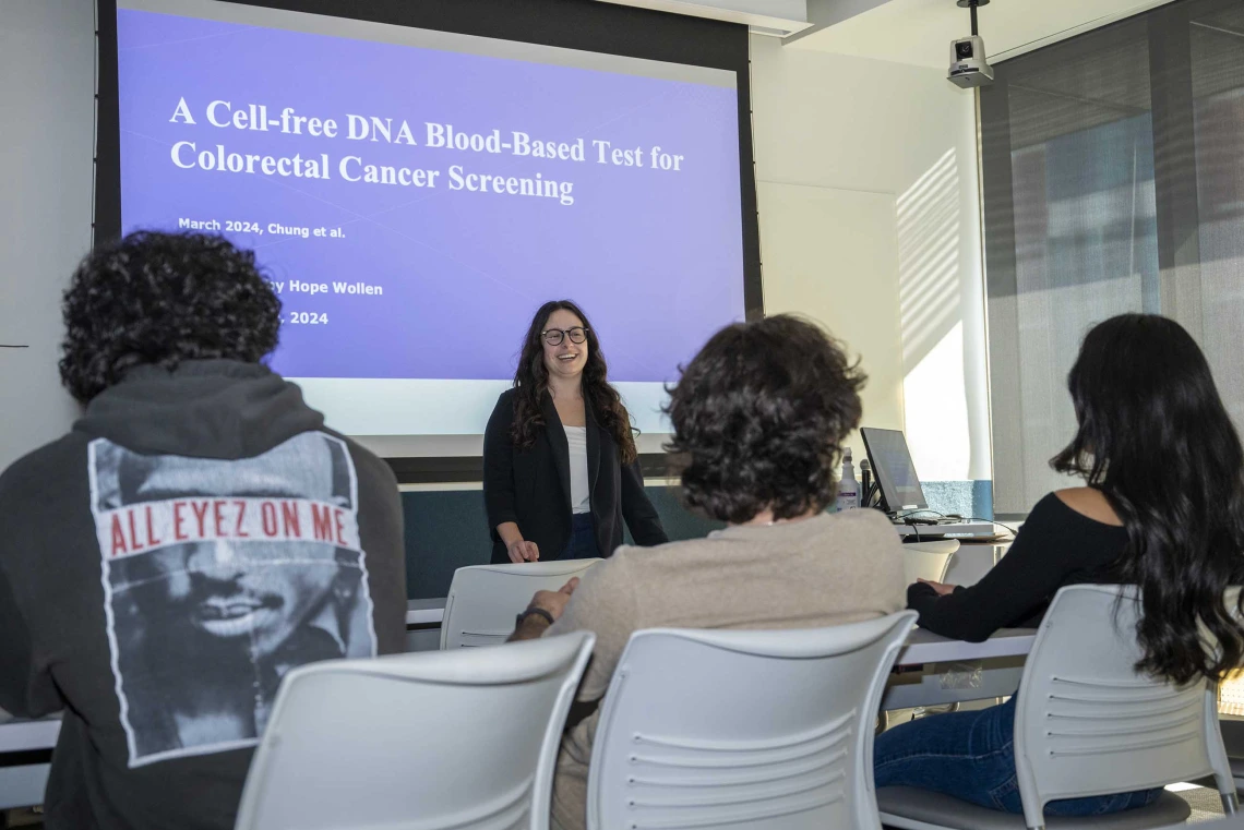 U of A College of Health Sciences student Hope Wollen in front of a class giving a presentation on colorectal cancer screenings