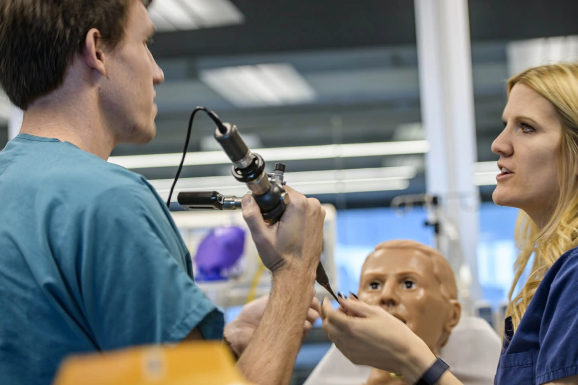 An internal medicine student practices on a simulated airway.