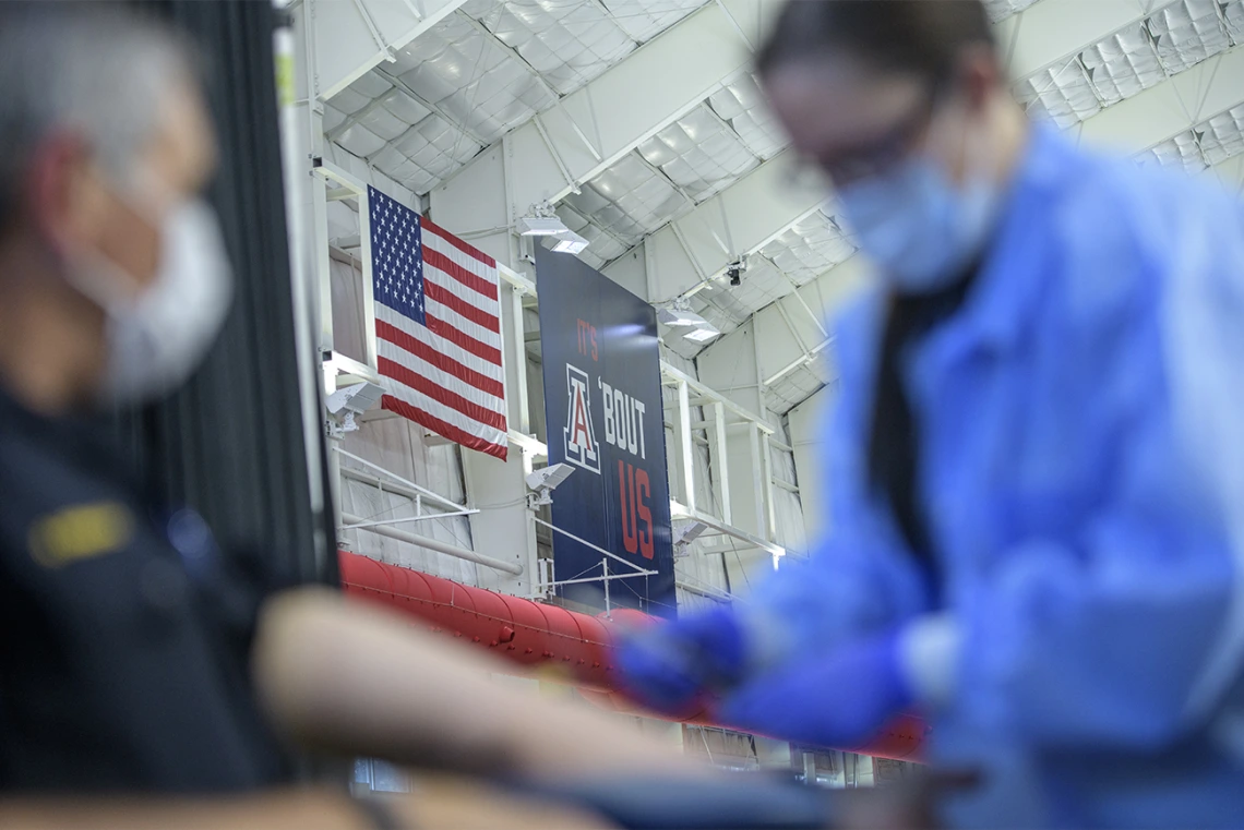 A health care worker prepares to apply a bandage to a police officer who has completed a blood draw for antibody testing April 30.