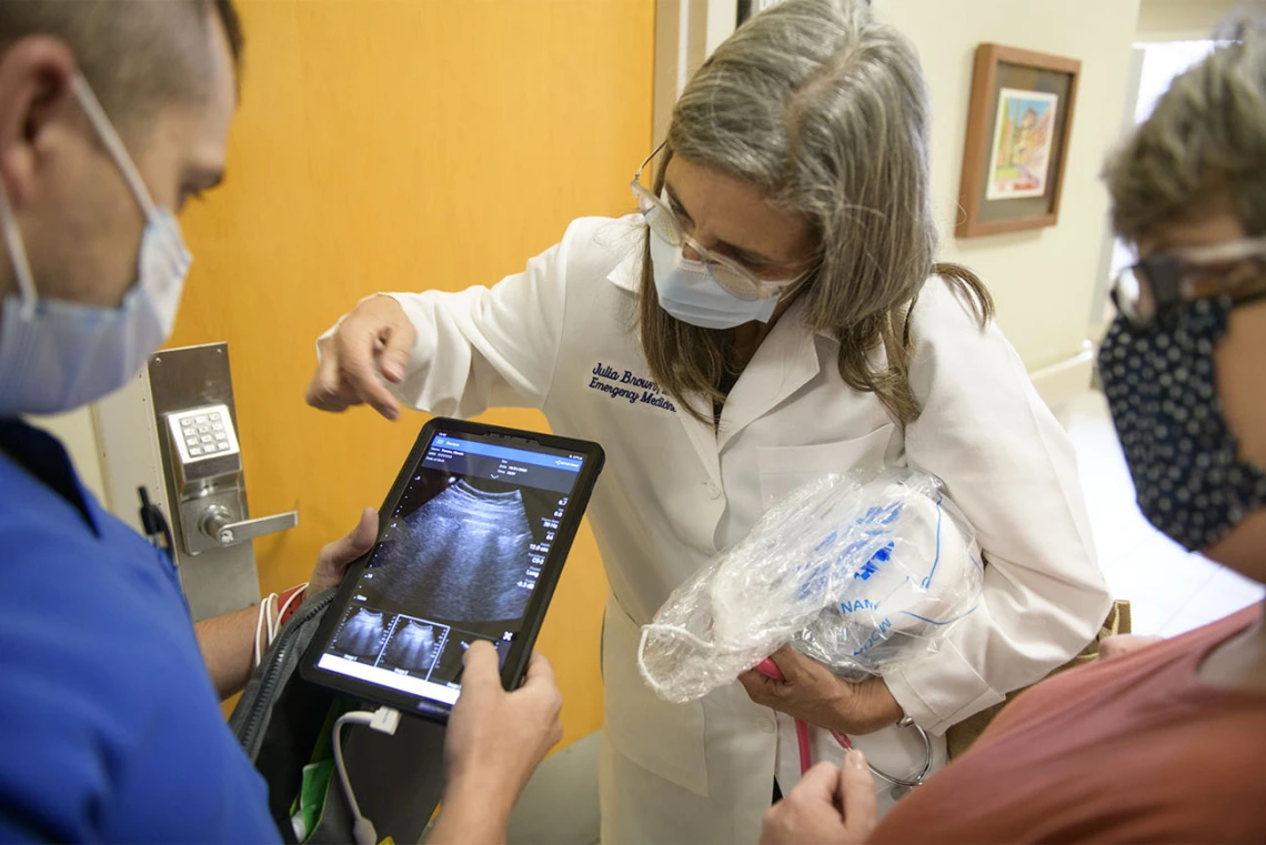 Cristian Laguillo, MD, Copper Queen Community Hospital inpatient medicine director, discusses the bedside ultrasound machine with Julia Brown, MD, and Glenda Trevino, RN, nursing education director. As a family medicine doctor, Dr. Laguillo was excited about the potential of this technology in non-emergency settings.