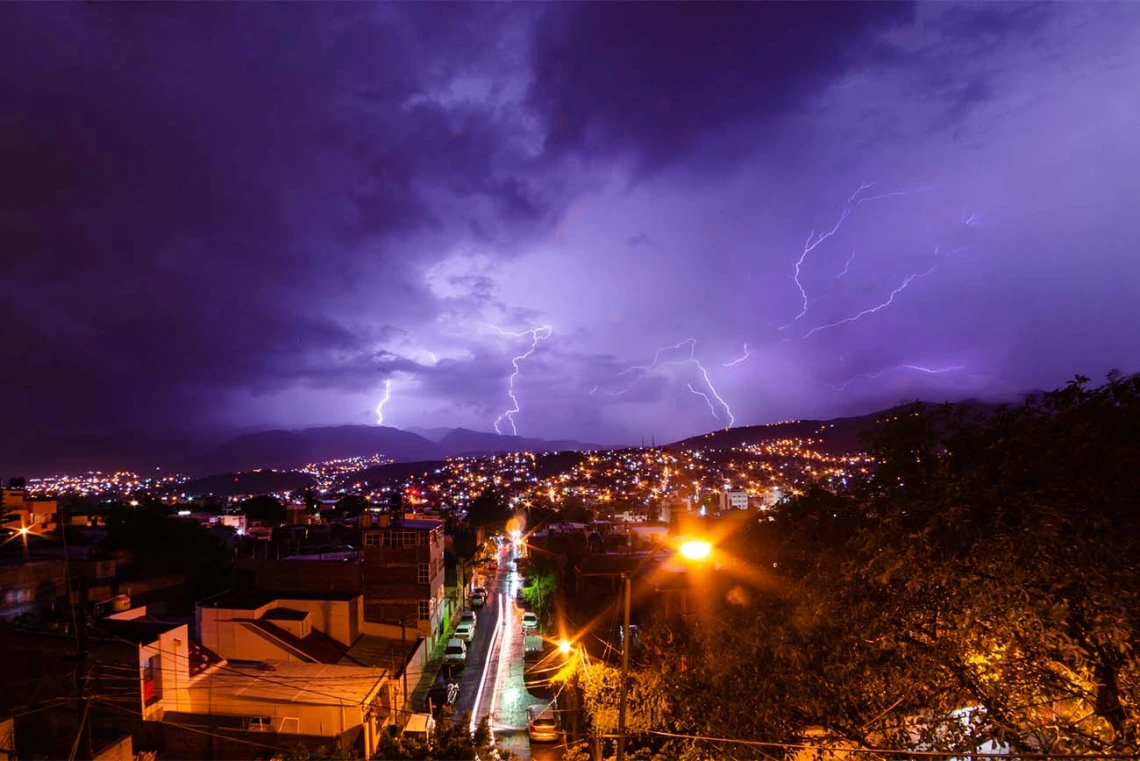 A darkened sky with an incoming storm over a city