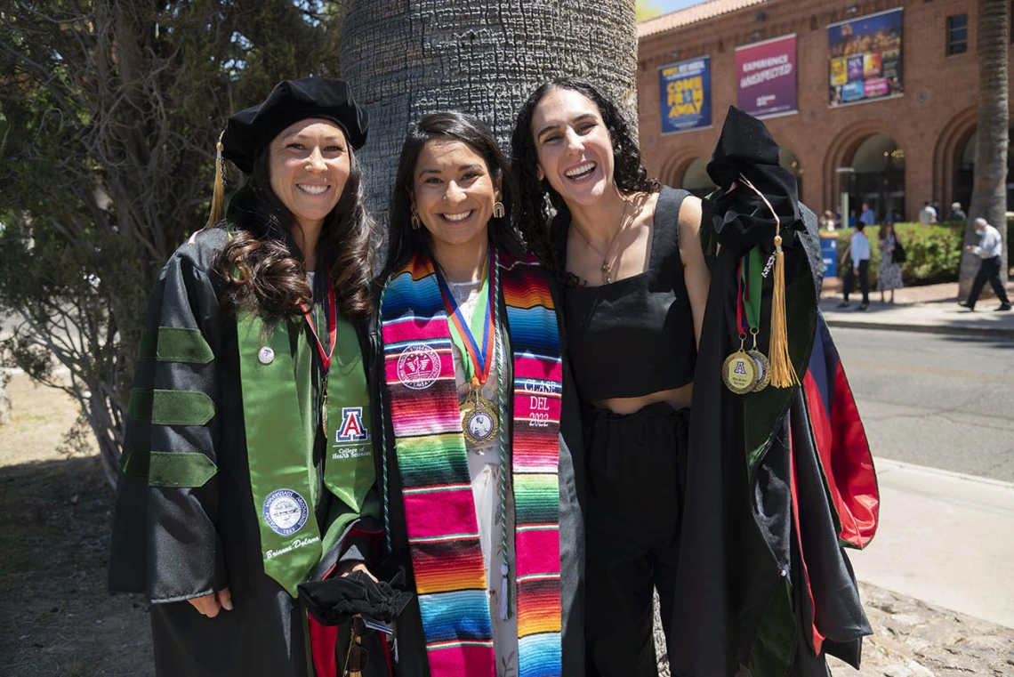 Brianna Dolana, MD, Naiby Rodriguez Zuniga, MD, and Cara Sasha Popeski, MD, pause to take a photo before their College of Medicine – Tucson class of 2022 convocation at Centennial Hall.