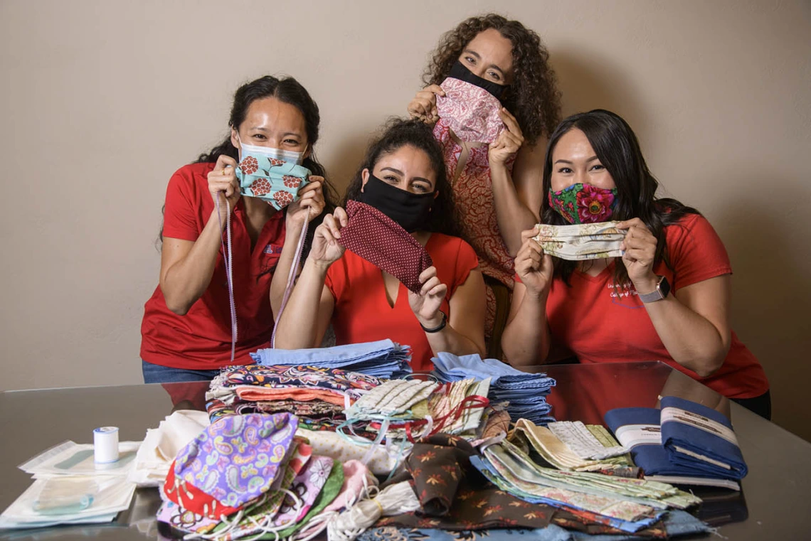 University of Arizona College of Medicine – Tucson students in the Commitment to Underserved People Program held a drive to help the Navajo Nation during the COVID-19 pandemic. Students Lynn Pham, Guadalupe Davila, Nicole Bejany and Thomasina Blackwater hold up face masks they sent to the Navajo Nation.