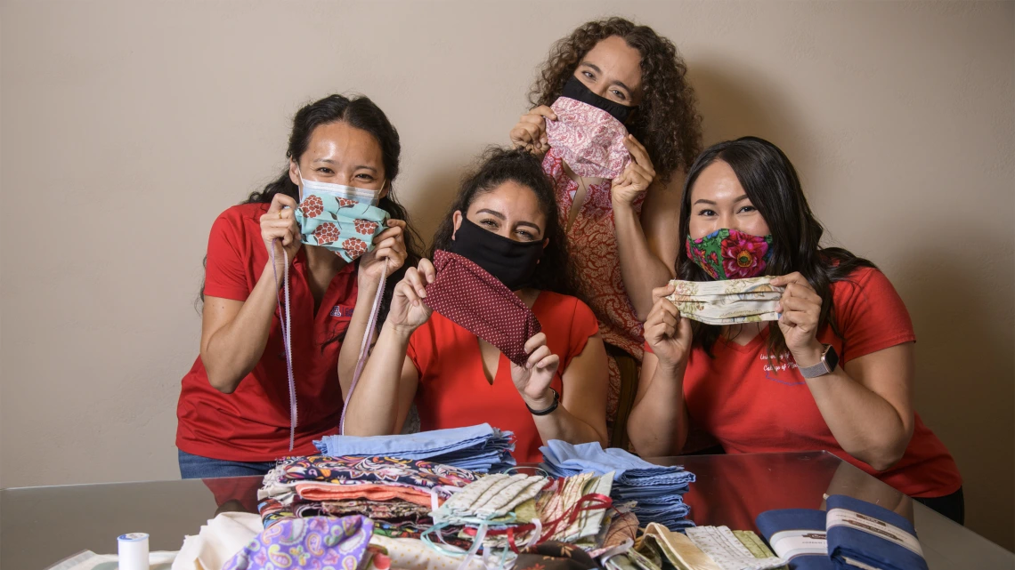 University of Arizona College of Medicine – Tucson students in the Commitment to Underserved People Program held a drive to help the Navajo Nation during the COVID-19 pandemic. Students Lynn Pham, Guadalupe Davila, Nicole Bejany and Thomasina Blackwater hold up face masks they sent to the Navajo Nation.