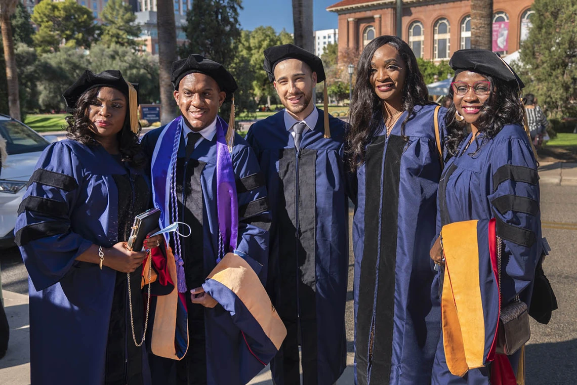 Doctor of Nursing Practice students (from left) Christiana Billedalley, Brian Harris, AZ Del Pino, Kengne Fosso and Jossy Mossle pause for a photo before heading into Centennial Hall for the College of Nursing fall convocation.