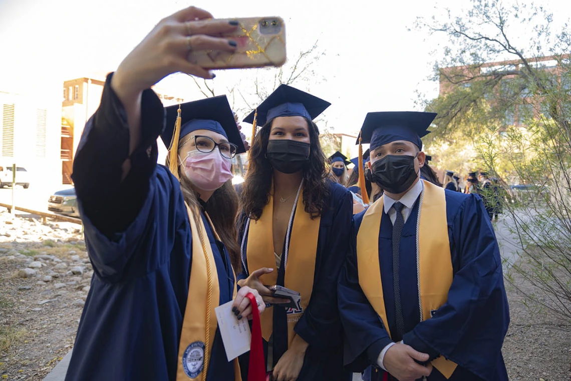 Nicole Cook takes a selfie with her fellow College of Nursing graduates, Gianna DeCero and Tom Dang at their fall convocation.