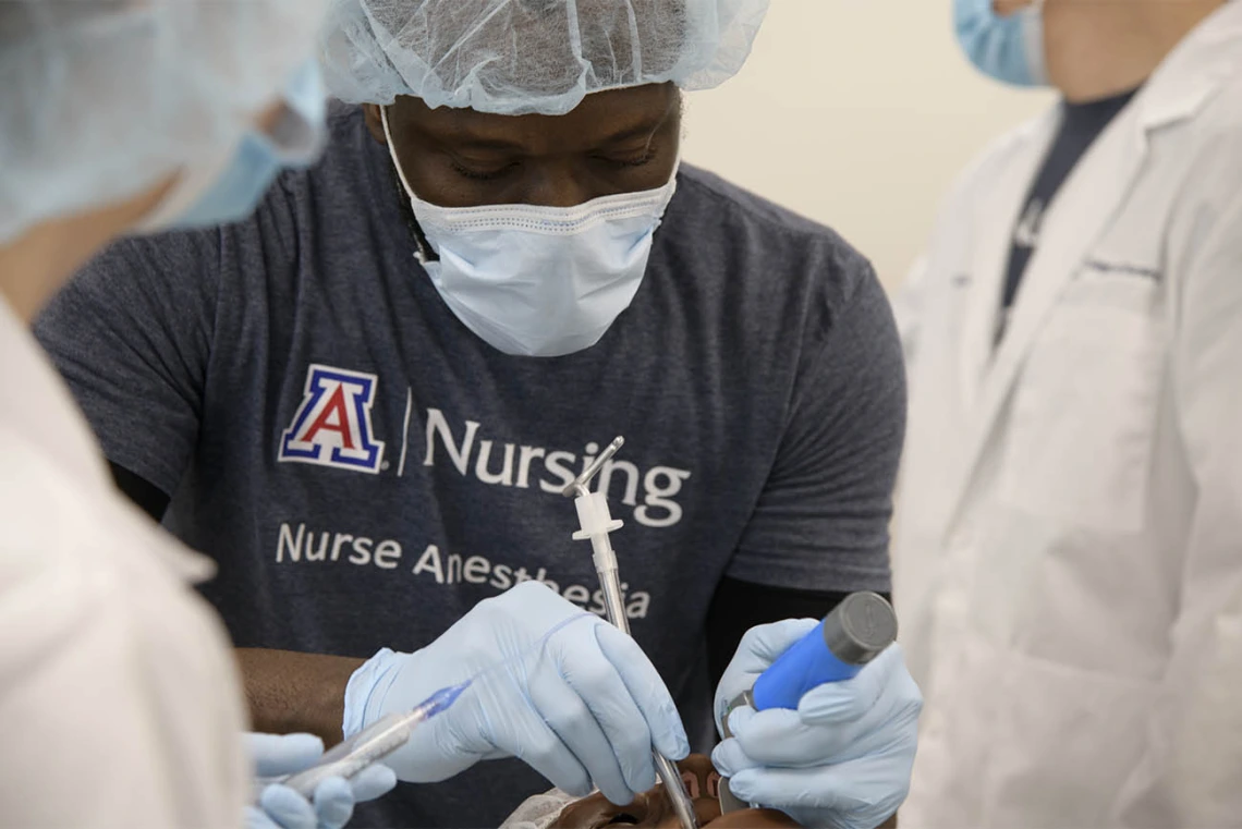 CRNA student Olu Bello, RN, intubates a manikin during a crisis management clinical skills intensive simulation in the Arizona Simulation Technology and Education Center. 