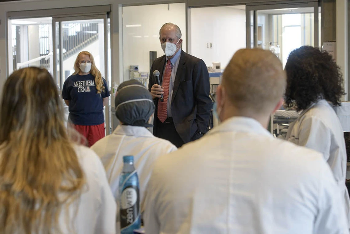 University of Arizona President Robert C. Robbins, MD, spoke to the class of second-year CRNA students and faculty during a break from their crisis management critical skills simulation. Standing next to Dr. Robbins is Kristie Hoch, DNP, CRNA, MS, RRT, Nurse Anesthesiology program administrator, who planned the crisis management scenarios that ran during the clinical skills intensive. 