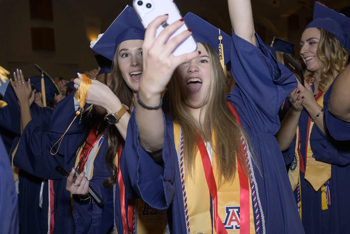 (From left) Bachelor of Science in Nursing graduates Bobbi Jackson and Katya Kirkland celebrate with a selfie during the UArizona College of Nursing fall convocation in Centennial Hall on Dec. 15.