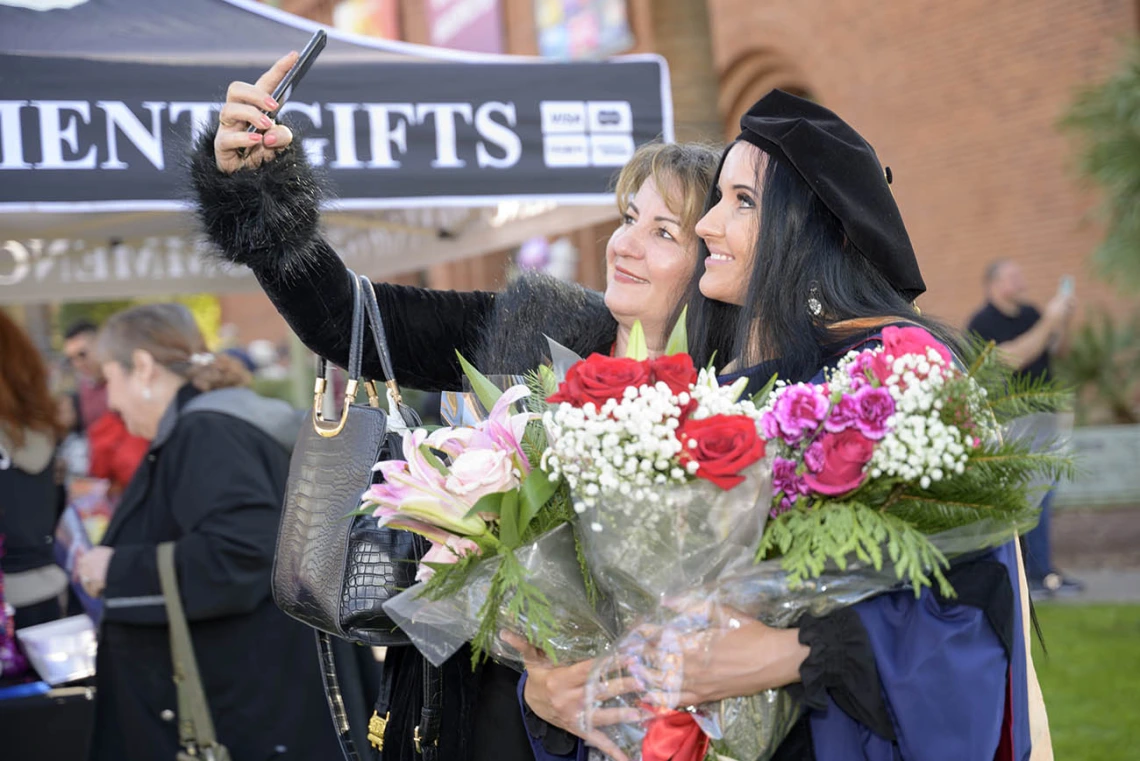 Doctor of Nursing Practice graduate Dragana Vojvodic (right) takes a photo with her mother, Drazana Kupusovic, at the UArizona College of Nursing fall convocation in Centennial Hall on Dec. 15.