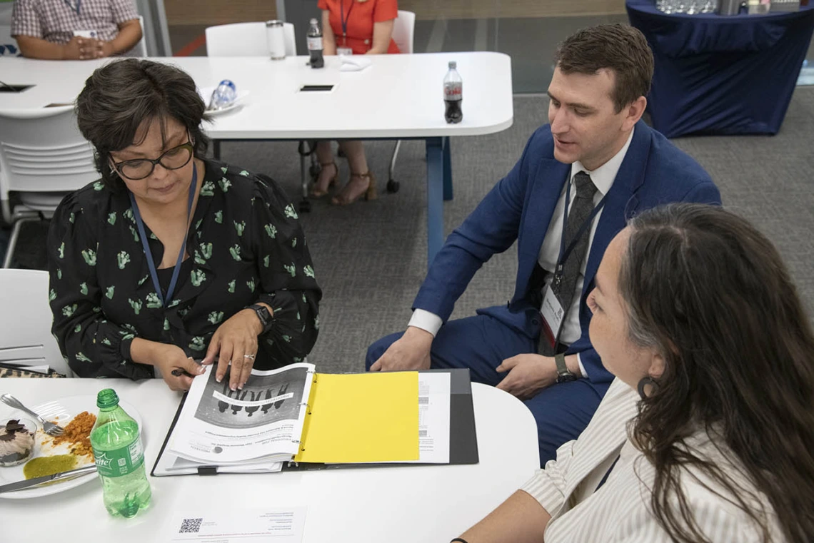 Ophelia Spencer, Ben Brady, PhD, and Alyssa Padilla discuss the UArizona Health Sciences Comprehensive Pain and Addiction Center’s paraprofessional training programs, Project FUTRE and PeerWORKS, during a luncheon for community partners.