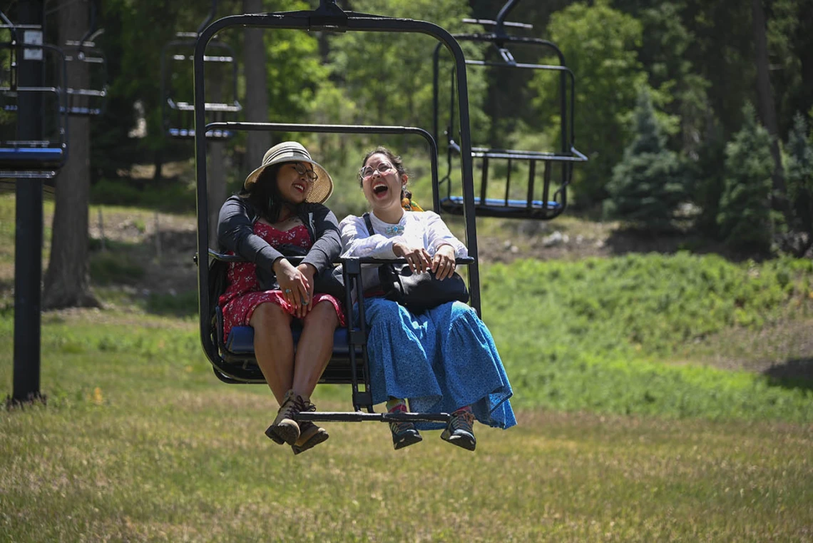 Diné College student Alyssa Joe (left) and program manager Kaitlyn Haskie enjoy a break from the heat while on a field trip to Mt. Lemmon as part of their neurosciences internship.