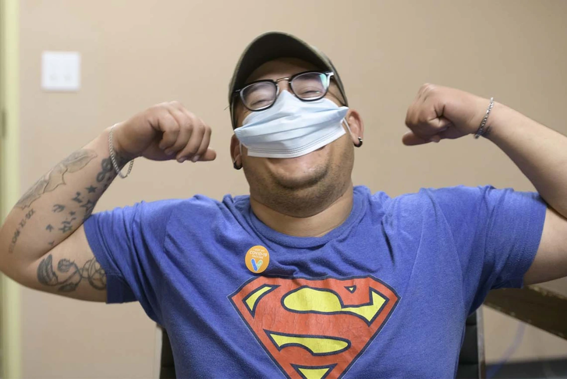 Rubén Sosa, a farm work supervisor, stretches after his shot to get greater circulation of the COVID-19 vaccine throughout his system.