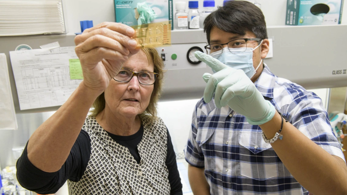 Dr. Anne Cress (left) devotes her career to decoding cellular conversations. She hopes it will lead to drugs that can “talk” to cancer cells.