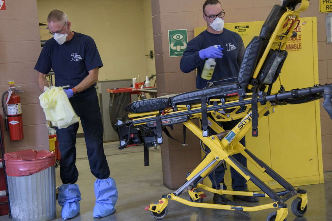 Tucson Fire Department’s Chris LaFave, left, and Taylor Parrish sanitize equipment after transporting a possible COVID-19 patient to the hospital. The University of Arizona Mel and Enid Zuckerman College of Public Health worked in conjunction with Tucson Fire Department and the Western Regional Public Health Training Center to create a training video about protocols for first responders to avoid infection during an outbreak.