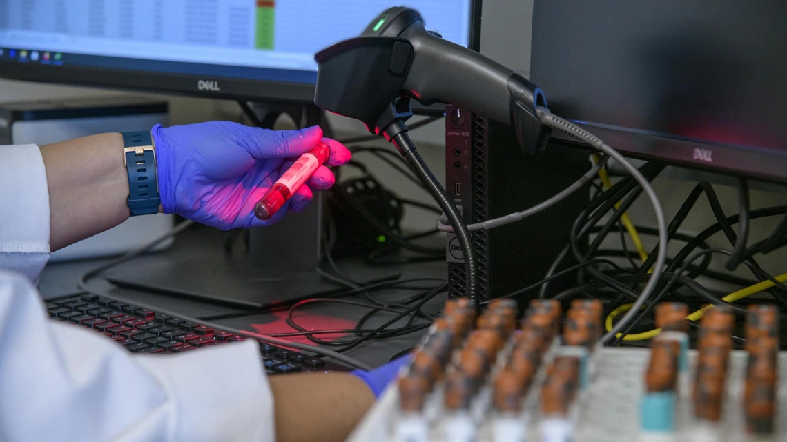 Lab technician Gina Delgado registers blood samples before they are processed to determine if they show antibodies to the virus that causes COVID-19.