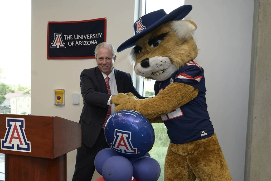 Wilbur Wildcat jokes around with University of Arizona President Robert C. Robbins, MD, at the UArizona College of Nursing’s ribbon-cutting ceremony in Gilbert, Arizona.