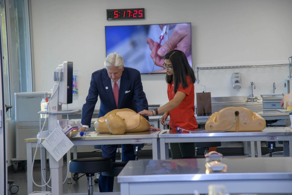 Examining a manikin on the ASTEC simulation area on the seventh floor.