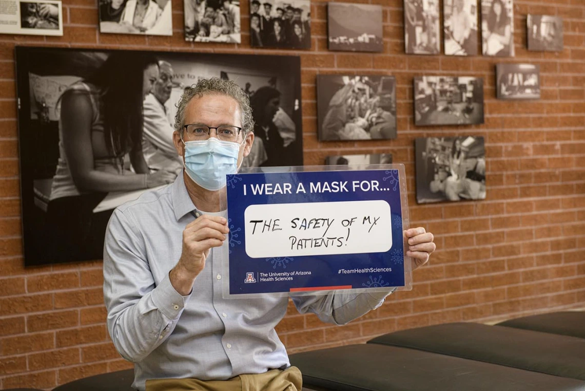 Conrad Clemens, MD, MPH, senior associate dean for graduate medical education at the College of Medicine – Tucson, is modeling safe practices for patients and family.