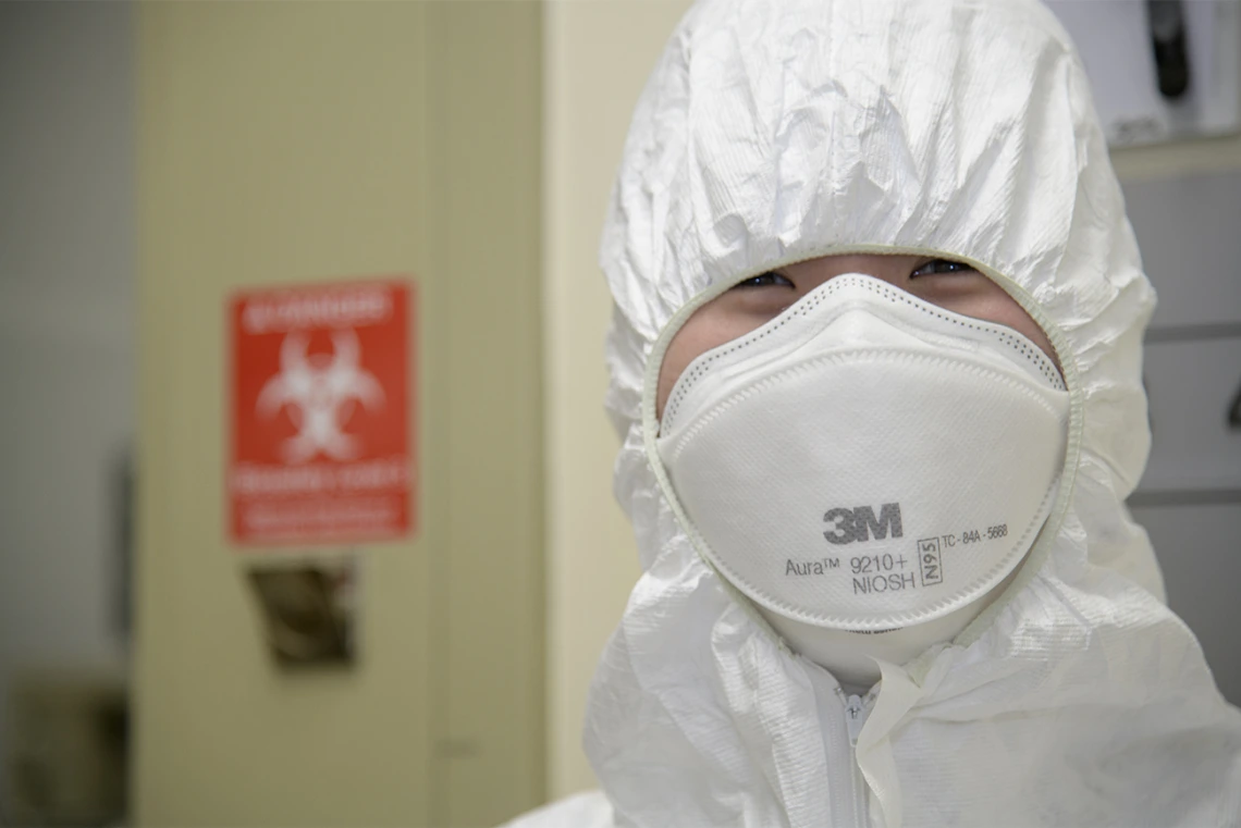 Rachel Wong, a graduate trainee in the Bhattacharya lab, is wearing head-to-toe PPE as she prepares to enter the Biosafety level 3 lab in April to work with samples of the live virus that causes COVID-19.